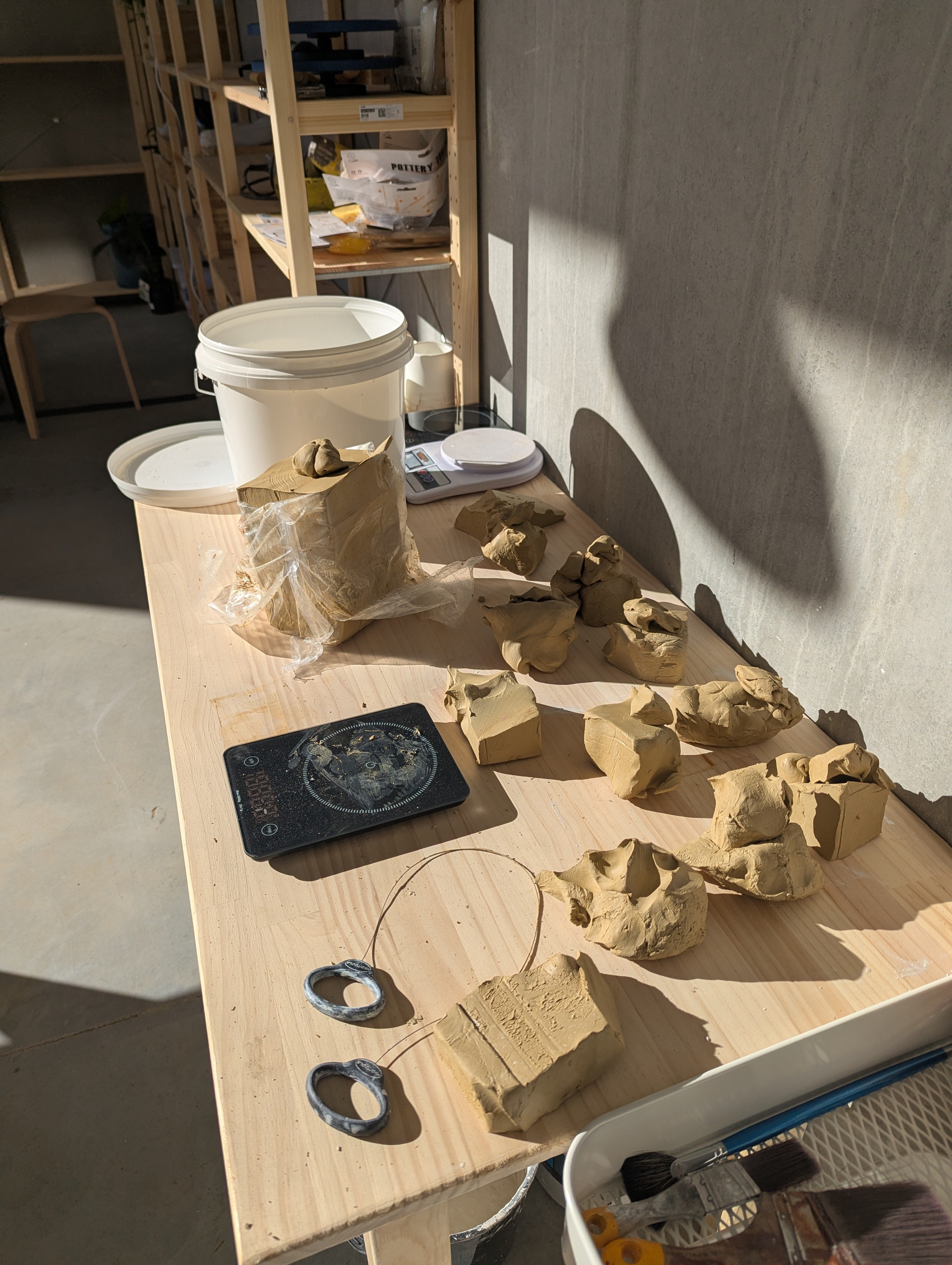 Worktable with clay sculptures and tools in a workshop setting